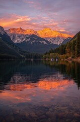 Fototapeta premium Golden sunset paints majestic mountains and tranquil lake with sailboats reflecting vibrant hues, evoking serenity and awe