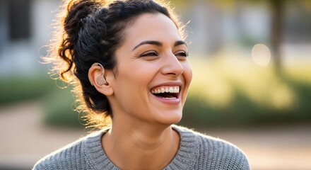 Joyful woman with curly hair laughing in a sunny outdoor setting