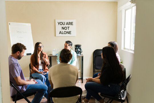 Group of people attending support therapy session - Powered by Adobe