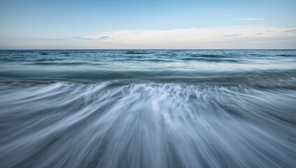 Fototapeta premium Captivating slow-motion waves crash onto the tranquil shore, creating a serene and dynamic ocean seascape with soft pastel skies