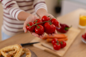 Woman holding fresh organic tomatoes for healthy cooking