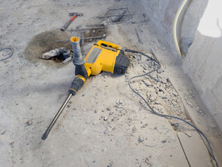 Electric Jackhammer Breaking Concrete with Rebar