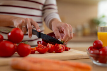 Woman's hands chopping fresh vegetables for healthy cooking
