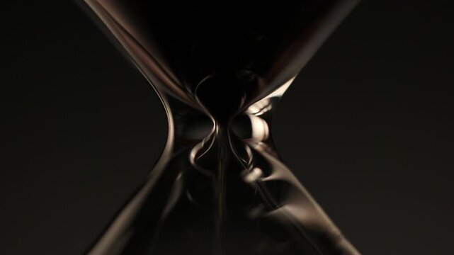 macro shot of sand flowing through the narrow neck of an hourglass, symbolizing time passing, balance, and the delicate rhythm of each second.