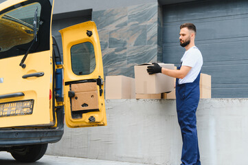 Courier unloading cardboard boxes from delivery van