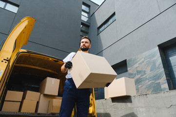 Delivery man carrying package from delivery van
