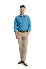 Happy casual man standing with hands in pockets