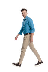 Naklejka premium Happy casual man walking and looking back