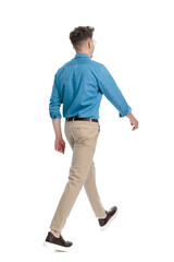 Fototapeta premium Back view of casual man with glasses walking