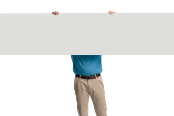 Fototapeta premium Casual man holding long blank billboard over head
