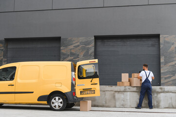Courier loading cardboard boxes into a delivery van