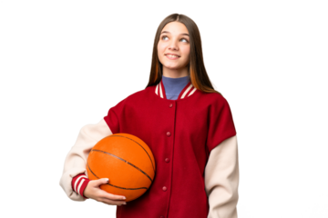 Teenager girl playing basketball over isolated chroma key background thinking an idea while looking up