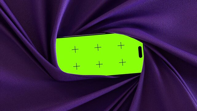 Purple fabric wraps and flows around a rotating smartphone with green screen creating elegant reveal motion for mockup design