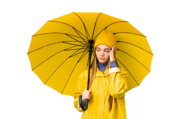Teenager girl with rainproof coat and umbrella over isolated chroma key background with headache