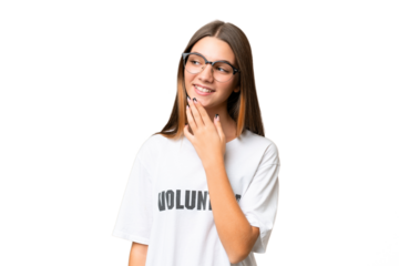 Teenager volunteer caucasian girl over isolated background looking up while smiling