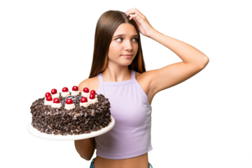 Teenager caucasian girl holding birthday cake over isolated background having doubts and with confuse face expression
