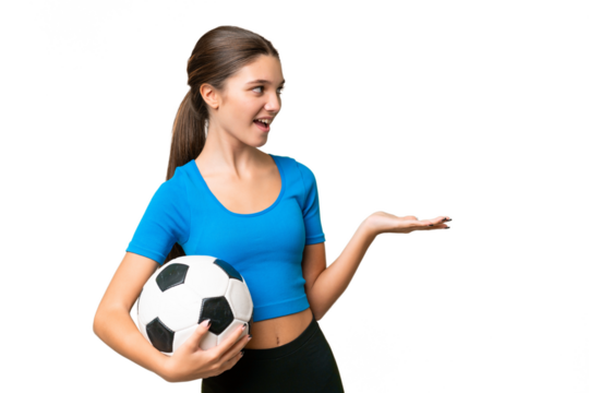 Teenager caucasian girl playing football over isolated background with surprise facial expression