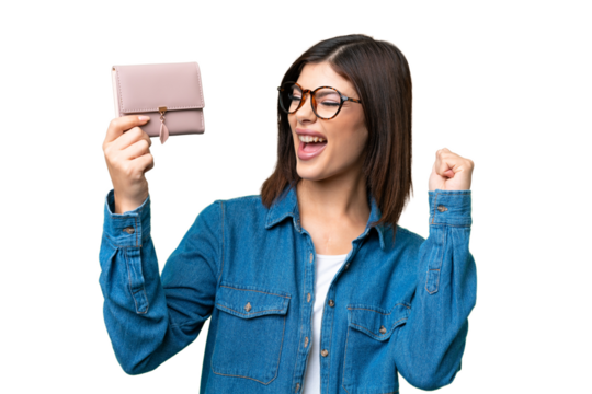 Young Russian woman holding a wallet over isolated chroma key background celebrating a victory