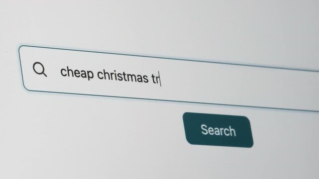 Cheap Christmas Tree Search on Search Engine. Close Up Shot of Typing Search Term in Search Box on Web Page on Computer Screen. Real Time 4K.