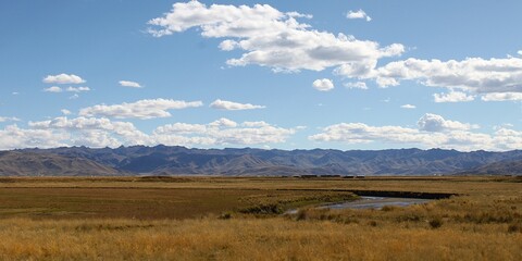 Puno, Peru: Panoramic view over Altiplano landscape to impressive mountain ridge in the Andean...