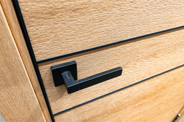 Modern black handle on wooden drawer in interior design showcasing contemporary furniture style and craftsmanship