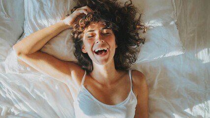 Laughing woman under soft duvet, candid joy and radiant expression turn quiet bedroom moments into relatable, upbeat lifestyle content that audiences love.
