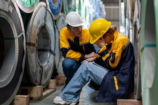 tired female worker feeling sick after stressed work in manufacturing factory, exhausted woman technician has problem working overload, foreman support consoling and encorage at industrial plant