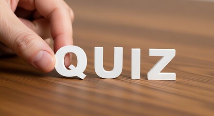 A hand places the last letter to complete the word quiz, symbolizing a test or game