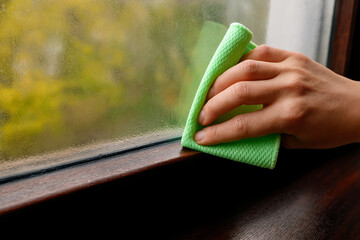 Hand Wiping Condensation From Window Glass