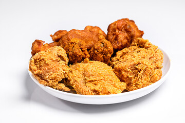 Fried chicken in white plate isolated on white background, tudio shot.