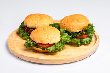 Close up of hamburgers on a wooden plate, Unhealthy food