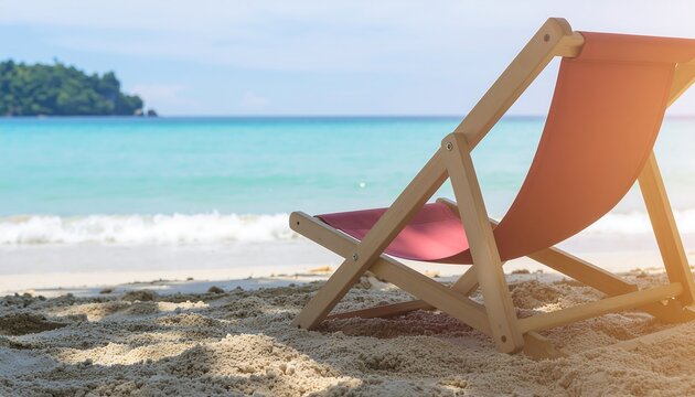 Idyllic summer vacation concept with a sun lounger on a tranquil tropical beach overlooking the turquoise ocean