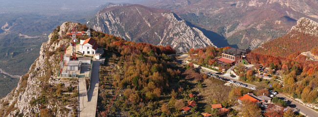 Aerial panorama of Sari Salltik viewpoint with communication towers, restaurants, and autumn forest on Kruj&euml; Mountain.