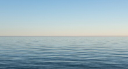 Obraz premium A vast expanse of tranquil water reflecting the soft light, extending towards the distant horizon beneath a clear, open sky. Serene view ,environment ,wide ,outdoors