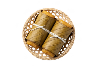Two traditional vietnamese banh tet glutinous rice cakes wrapped in banana leaves, tied with string, and presented in a woven bamboo basket, isolated on transparent background