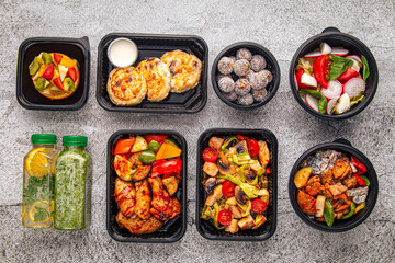 Balanced set of healthy meal prep containers with grilled chicken, vegetables, salads, desserts, and detox drinks