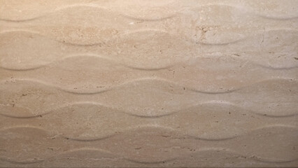 Fototapeta premium Texture of a cream tile or wall with a repeating diamond pattern.