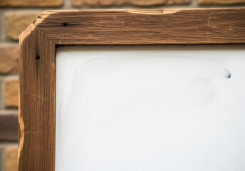 Rustic wooden frame with a blank white surface, showcasing natural textures and craftsmanship, ready for personalized messages or artistic expressions in a charming, traditional setting