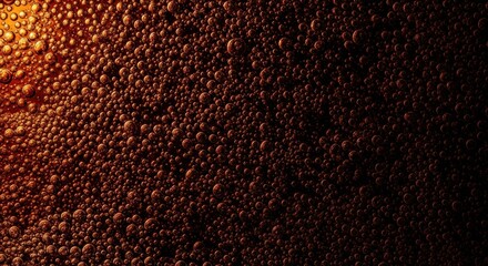 Abstract macro view of carbonated bubbles. Rich amber texture with dramatic lighting effect. Effervescent soda or beer concept for marketing. Dynamic organic pattern for a luxury backdrop