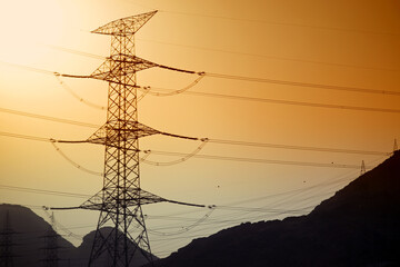 Dramatic power lines against warm gradient sky for infrastructure projects