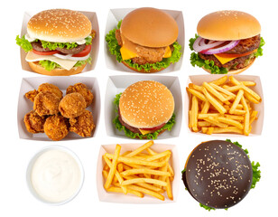 Assorted fast food items including burgers, fried chicken, fries, and dipping sauces arranged on a tray