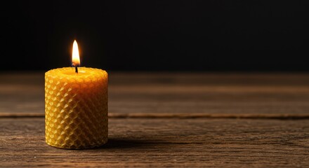 Golden beeswax candle burning brightly on a rustic wooden surface, highlighting the natural texture and warm atmosphere ,spiritual ,light ,warm