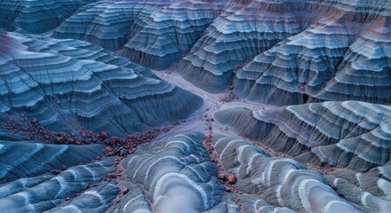Colorful badlands with layered sediment formations. Abstract aerial perspective of a unique geological landscape. Natural patterns for creative design and business presentations