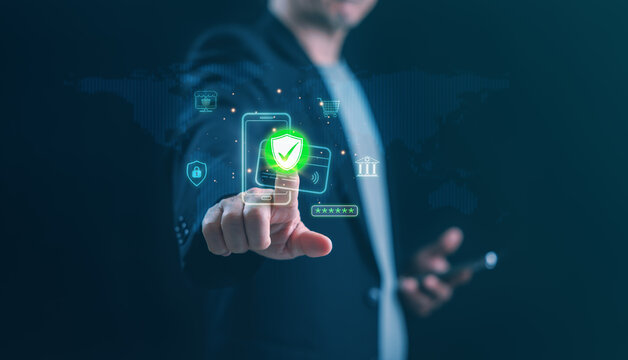 A businessman touches a glowing green shield on a virtual interface, representing online payment security, data protection, privacy, and cybersecurity in modern fintech systems.