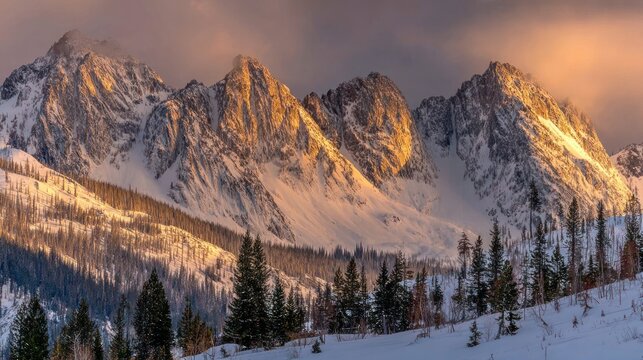 Snowy mountain peaks bathed in golden sunrise light - Powered by Adobe