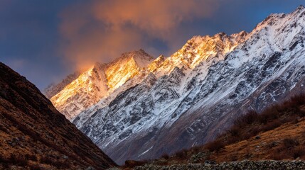 Golden sunrise on snow-capped mountain peaks