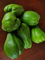 Fresh chayote squash on wooden table