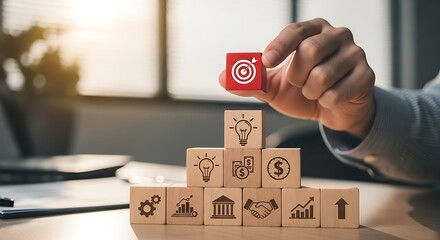 Reach goals with strategic business planning shown with wooden blocks stacked like a pyramid, representing success, vision and team work in a modern office