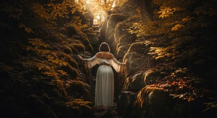 Fototapete Mädchenzimmer Woman in an ancient dress on a mystical journey through a rocky gorge. Fantasy narrative of exploration and discovery. Spiritual quest towards a divine light in a golden autumn forest  © Mr. Stocker