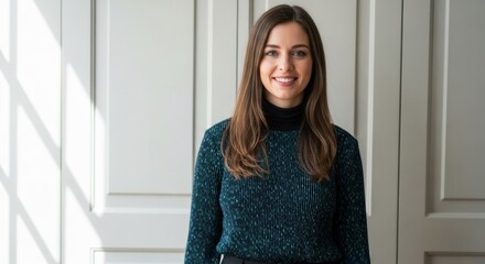 Portrait of a smiling young Caucasian businesswoman. Professional corporate headshot for company branding. Successful female entrepreneur in a modern office with natural light